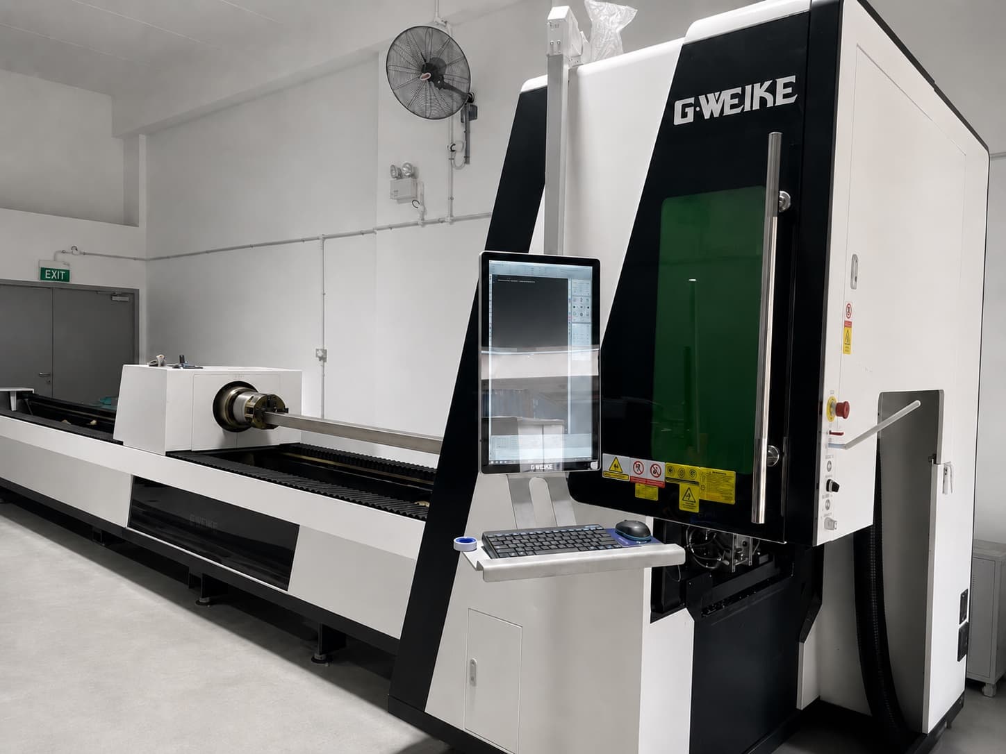 CNC laser tube cutting machine cutting a steel tube